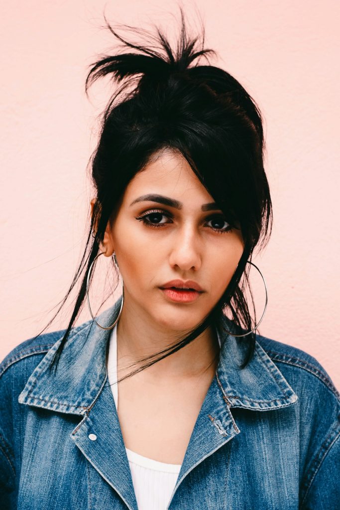 Representative editorial portrait of a woman wearing large hoop earrings.